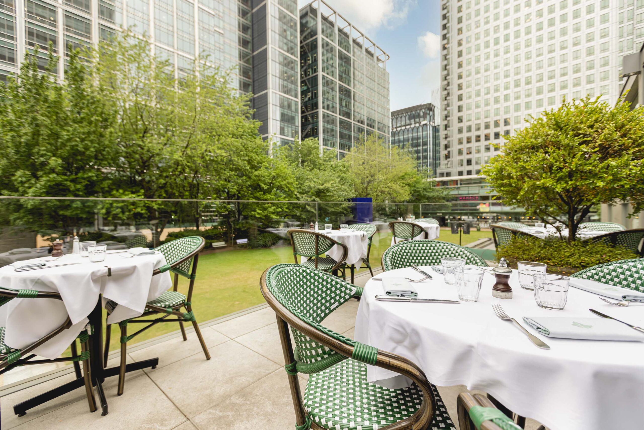 The Terrace at The Ivy In The Park in Canary Wharf with round tables.