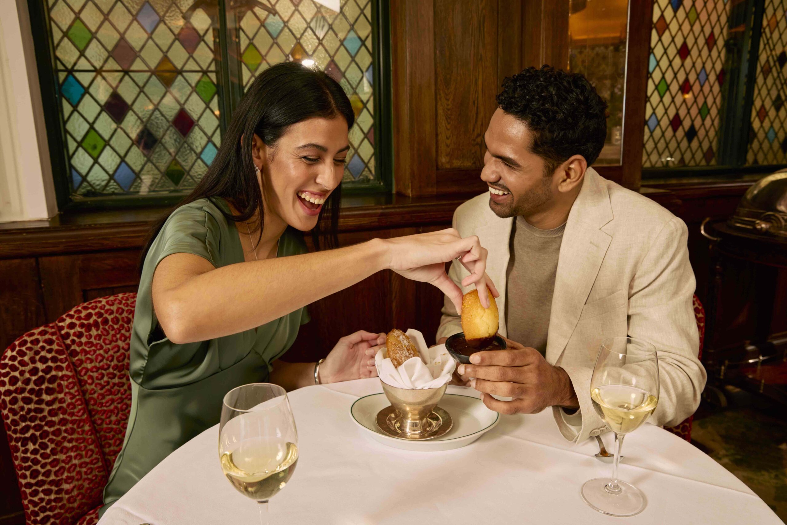 Guests enjoying steak and wine at The Ivy.