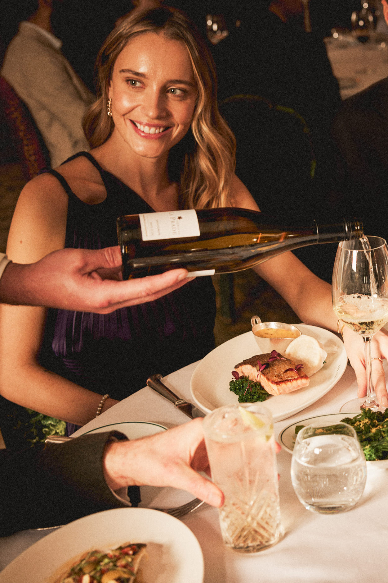 Female guest enjoying her meal and wine at The Ivy.