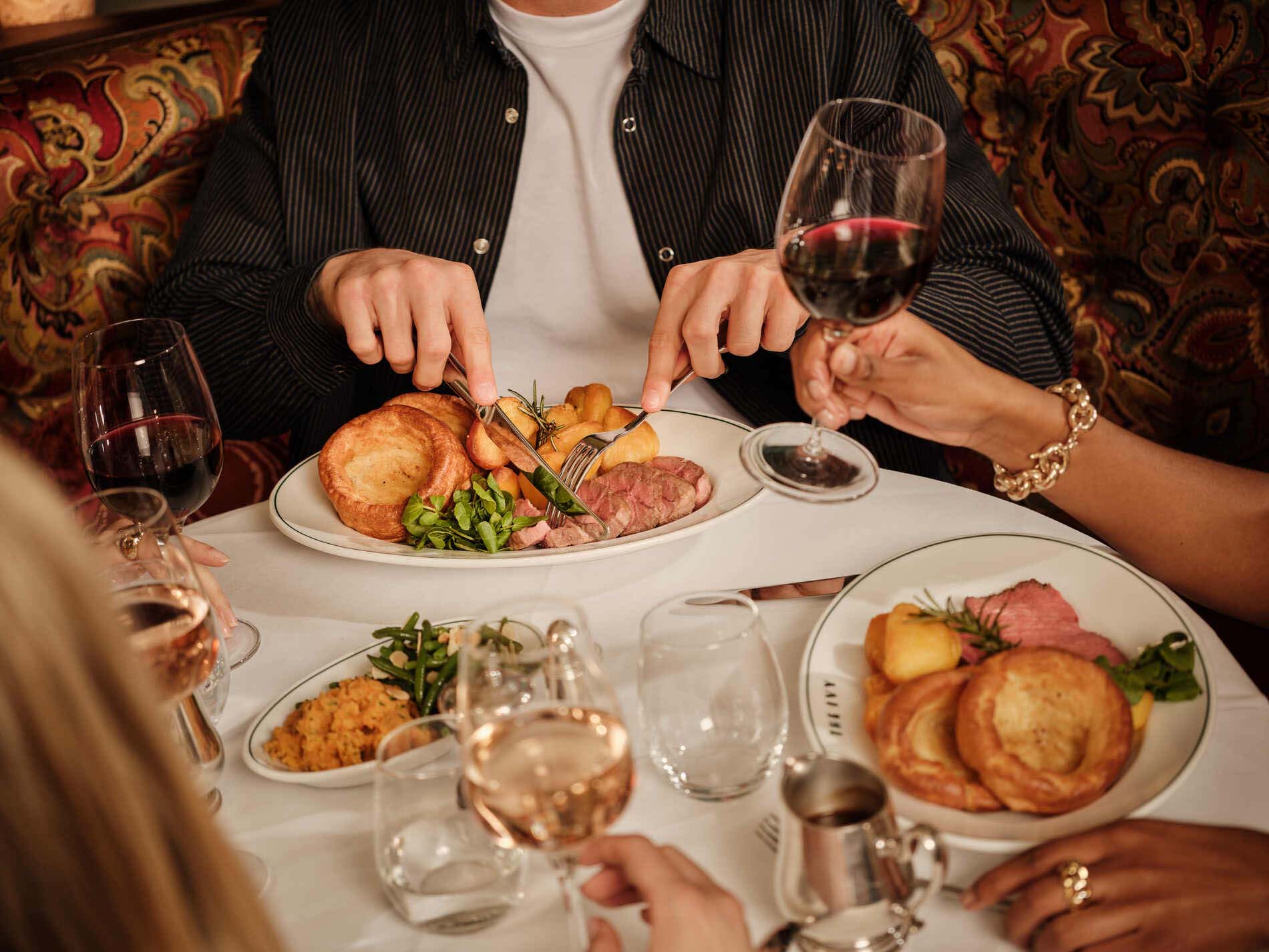 Guests having Sunday Roast at The Ivy.