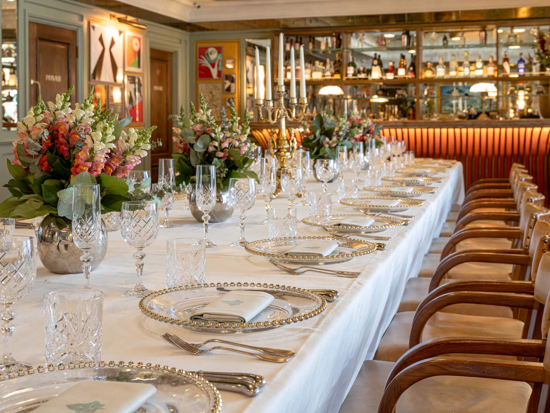 A close up photo of The Blake room PDR in The Ivy Soho. There is a long rectangle table in the middle of the room that is set up for a private dining event.