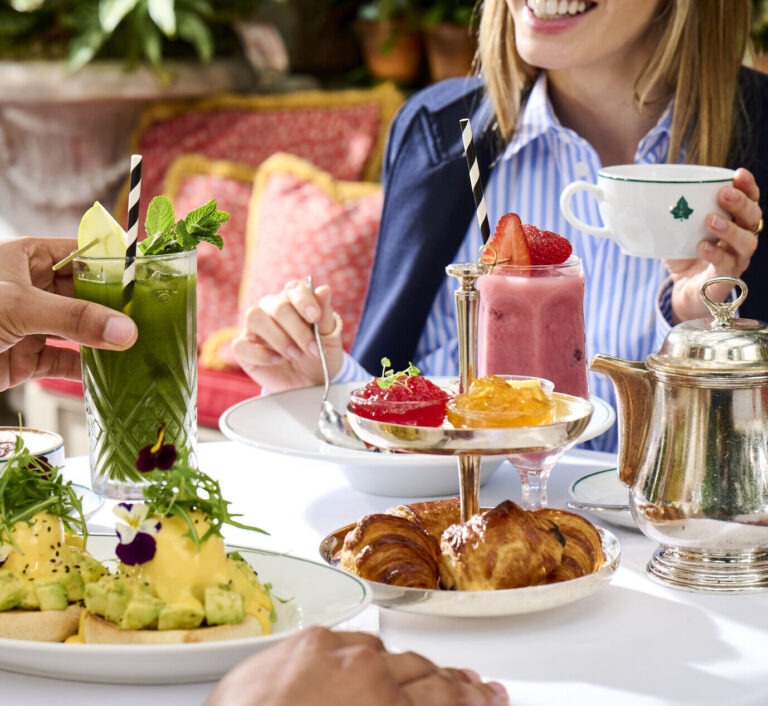 Guests having breakfast and smoothies at The Ivy restaurant.