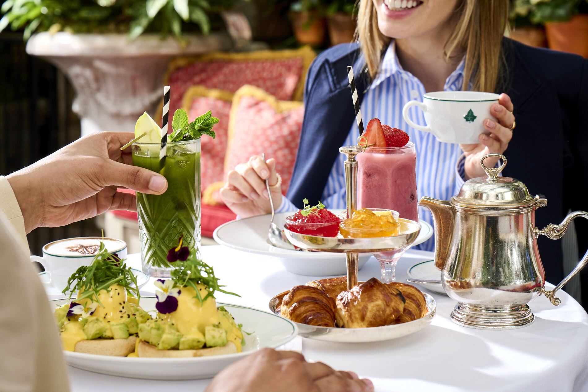 Guests having breakfast and smoothies at The Ivy restaurant.