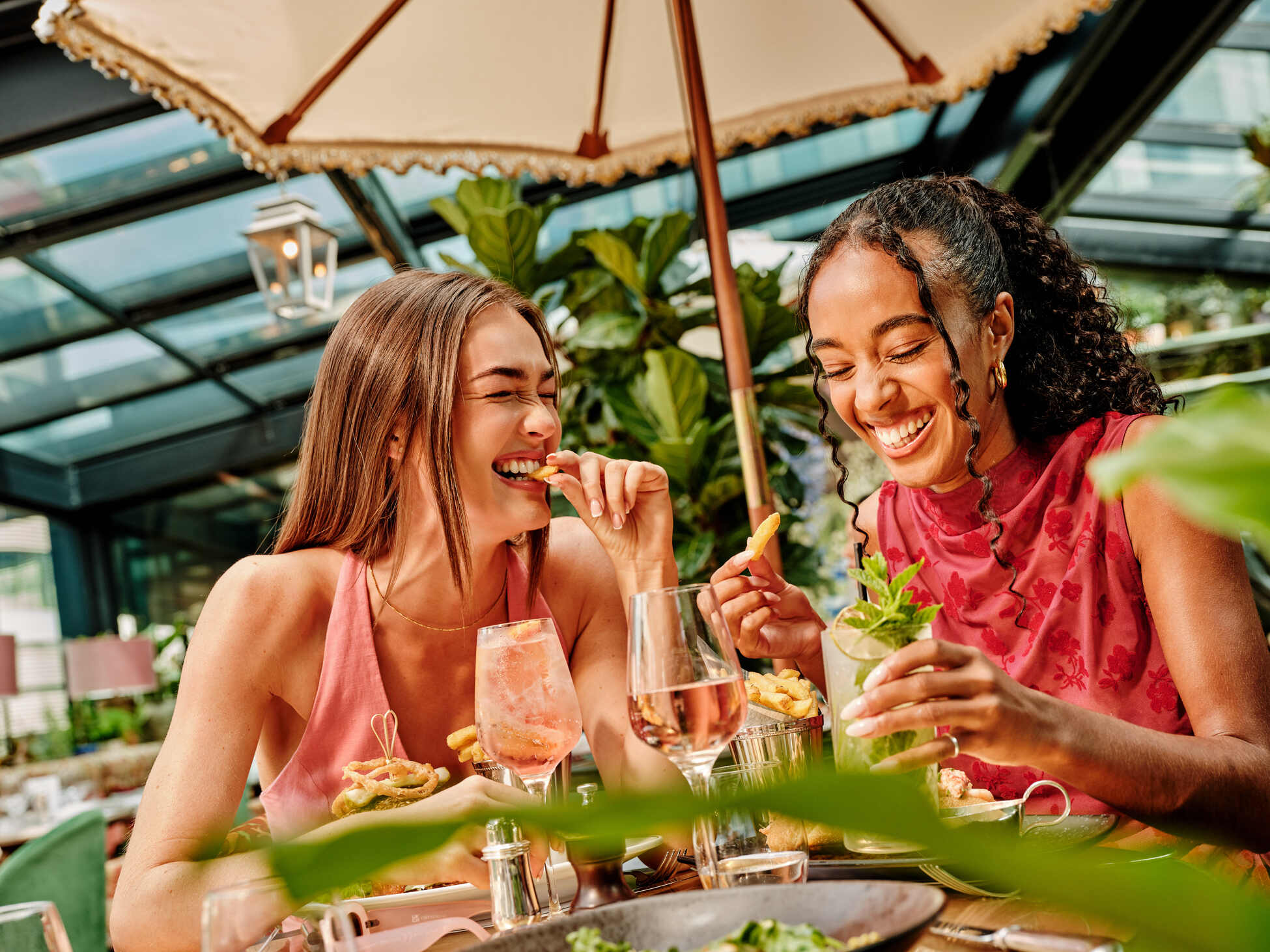 guests laughing together on rooftop bar in manchester